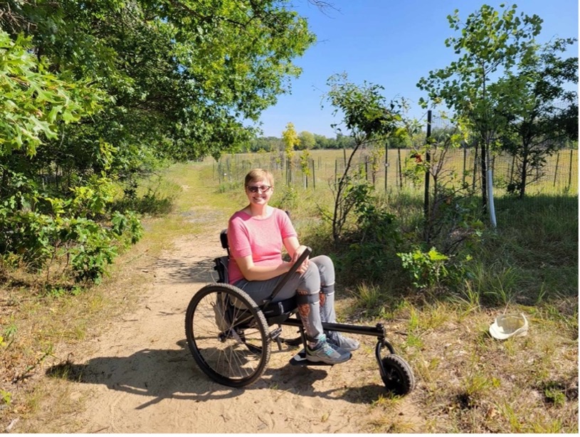 Charlotte with the GRIT Freedom Chair—a type of all-terrain manual wheelchair.